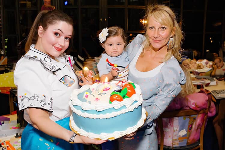 Two women holding the cake