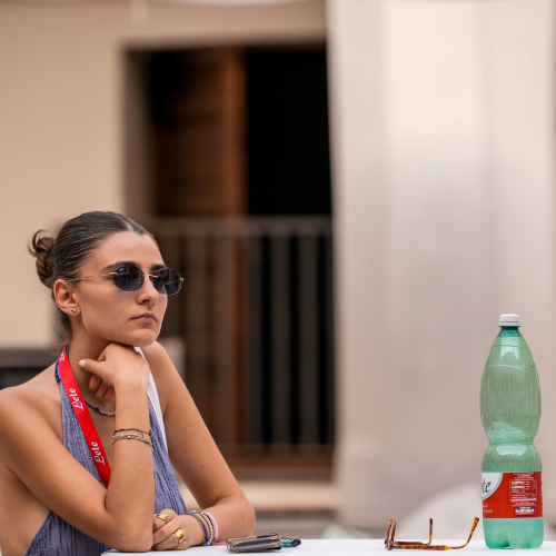 The woman sitting at the event